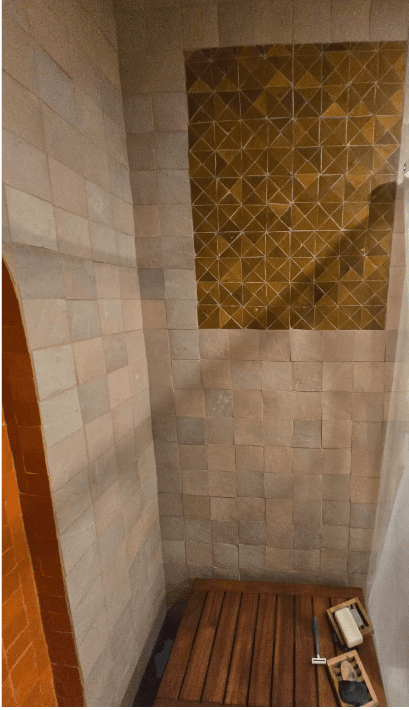 Shower with built-in bench and custom tile accent wall in Potomac MD