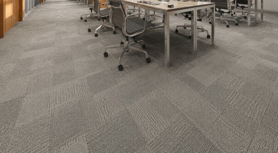 Gray Shaw carpet tile installed under office desks and rolling chairs in a modern commercial workspace