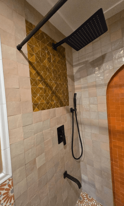 Custom shower with arched niche and patterned tile floor in Potomac MD