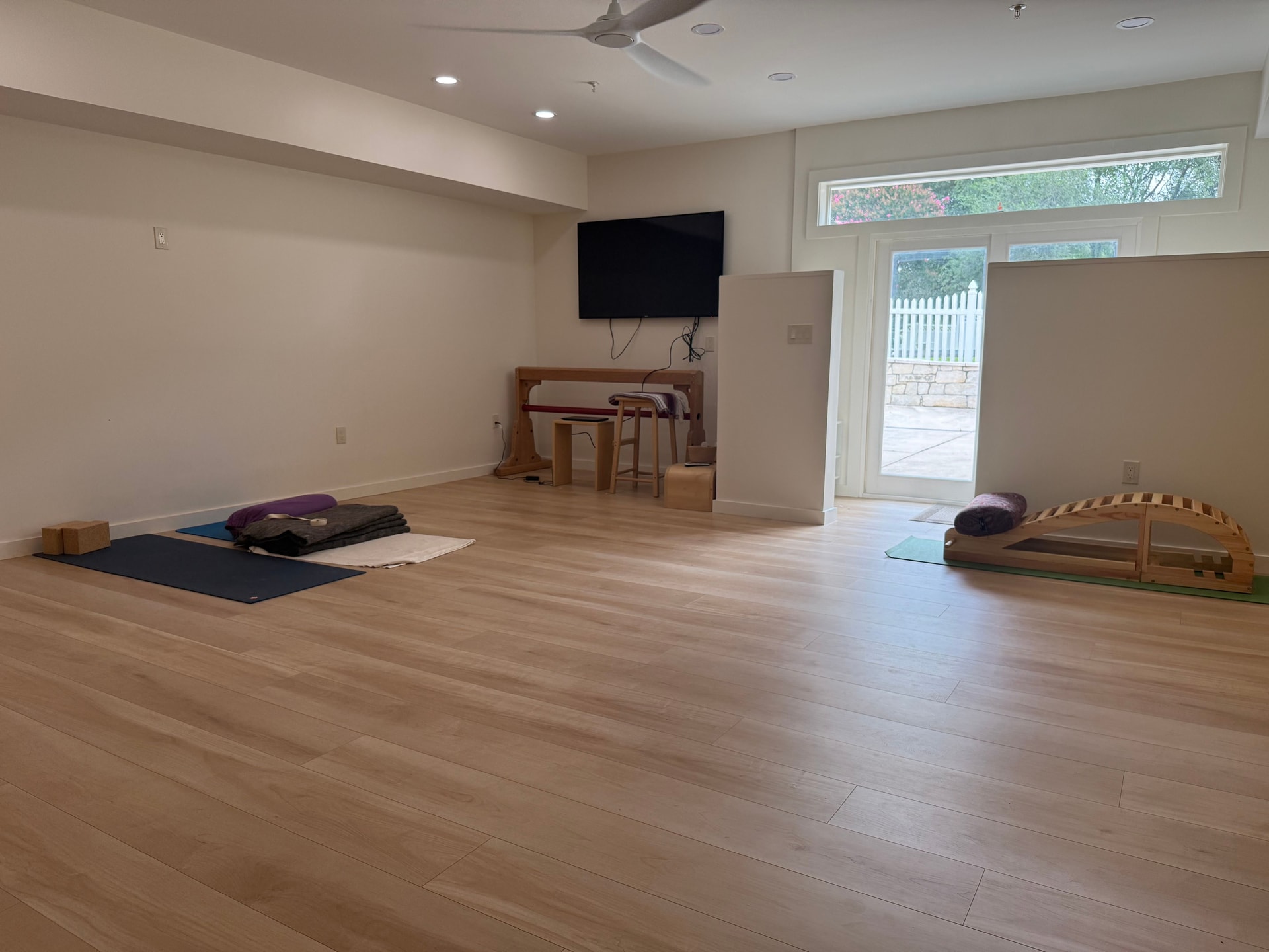 Light wood laminate flooring installed in a modern yoga studio in Rockville, MD by a flooring remodeling company.