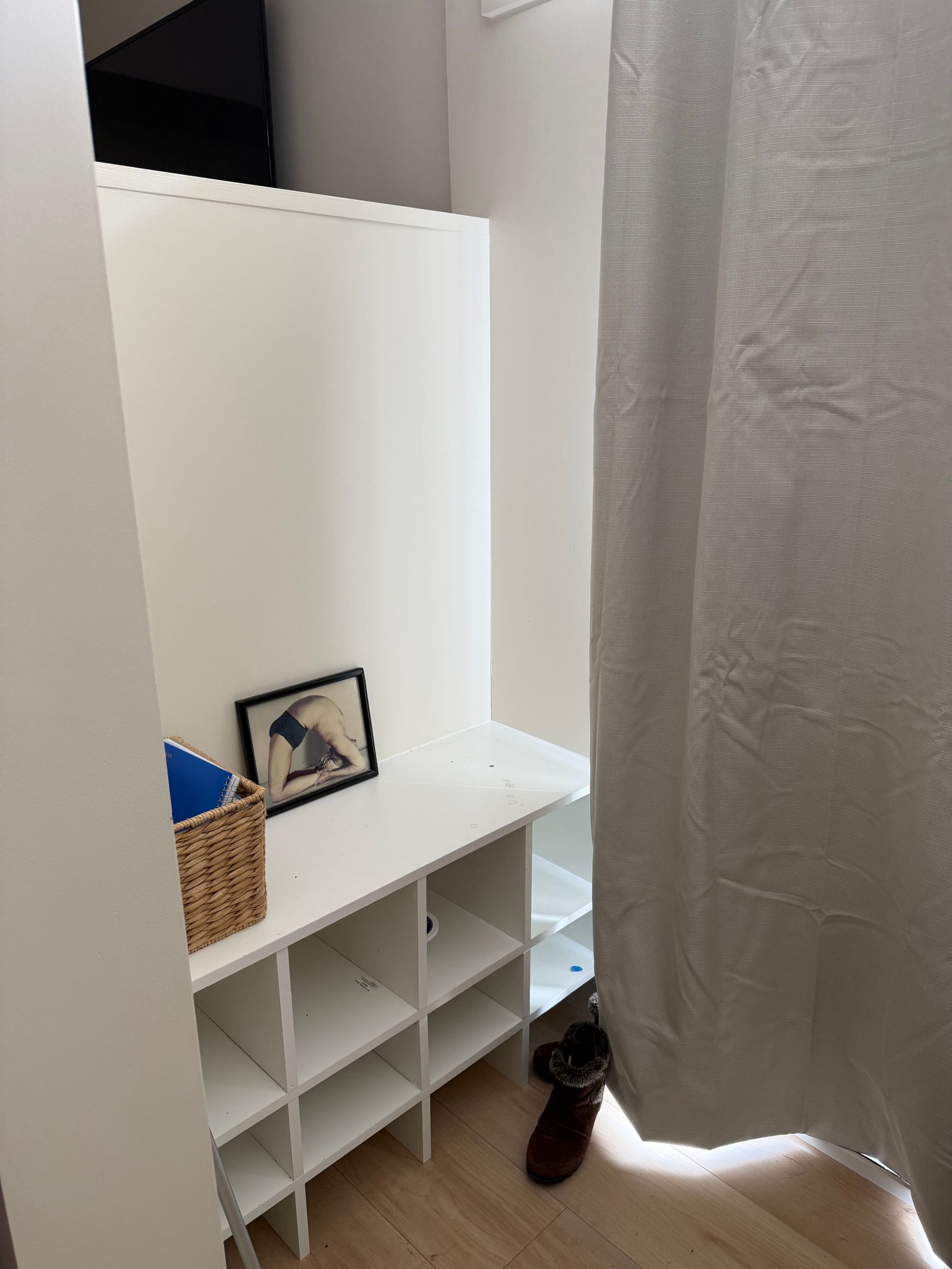 Custom shoe storage and entry organization area in a yoga studio remodel with light wood flooring in Rockville, MD.