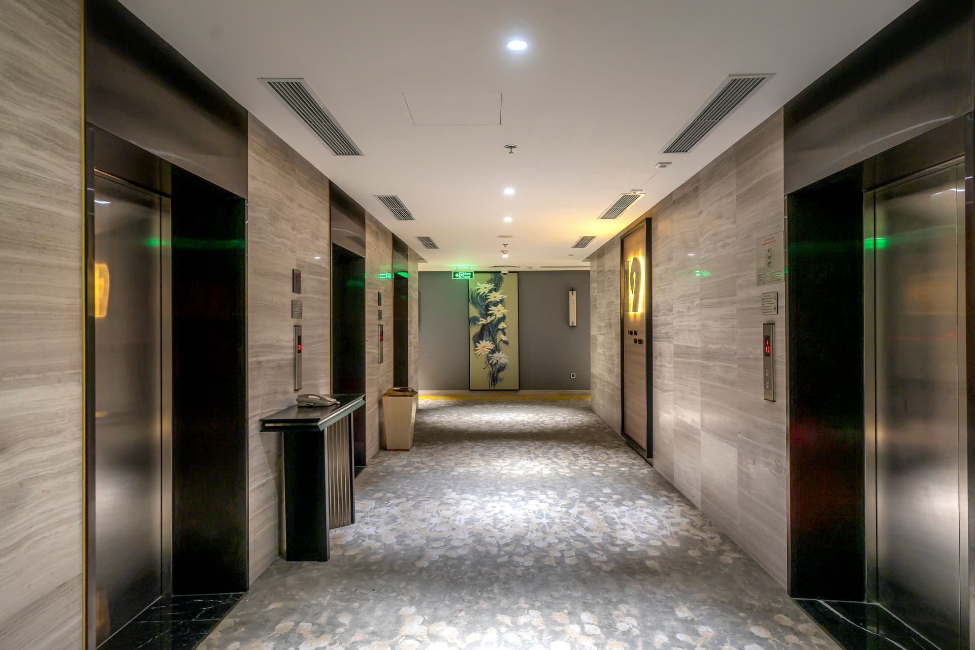 Patterned hotel corridor carpet — carpet quiets footsteps and luggage noise outside guest room doors