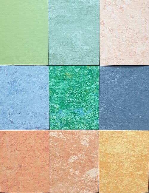 Samples of natural linoleum in a wide range of colors, showing the broad palette available across linoleum collections